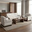 Cream leather 3-seater sofa with matching armchairs and walnut coffee table in a contemporary executive office lounge - RAMA Office Furniture