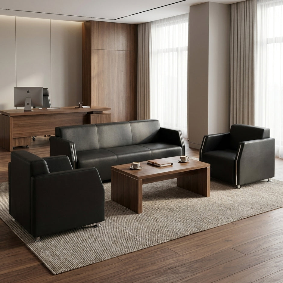 Black leather 3-seater sofa with matching armchairs and walnut coffee table in an executive office lounge area - RAMA Office Furniture